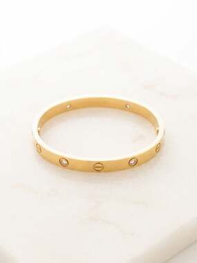 Trendy Fashion bangle with screw motif and 4 zircon stones.